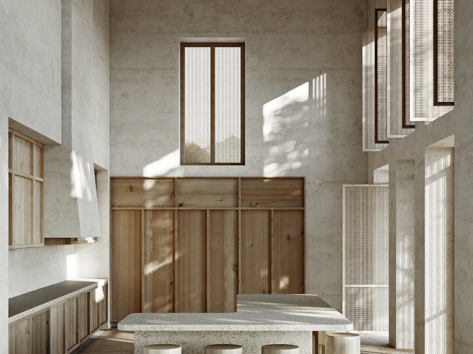 Elegant minimalist kitchen interior with wood accents and high ceilings. Perfect for modern design inspiration.